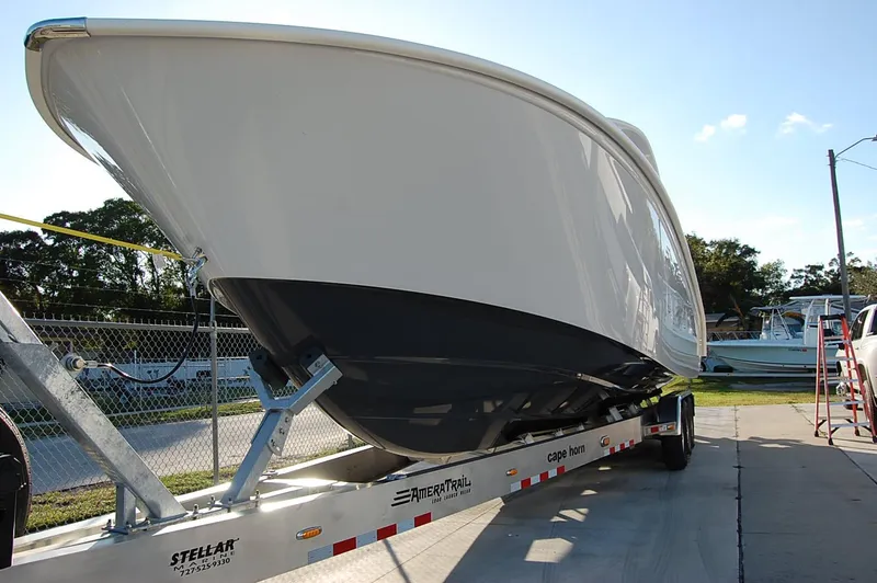 Slide: The Image of 2025 Cape Horn 36 XS boat on a trailer in a marina. - 2