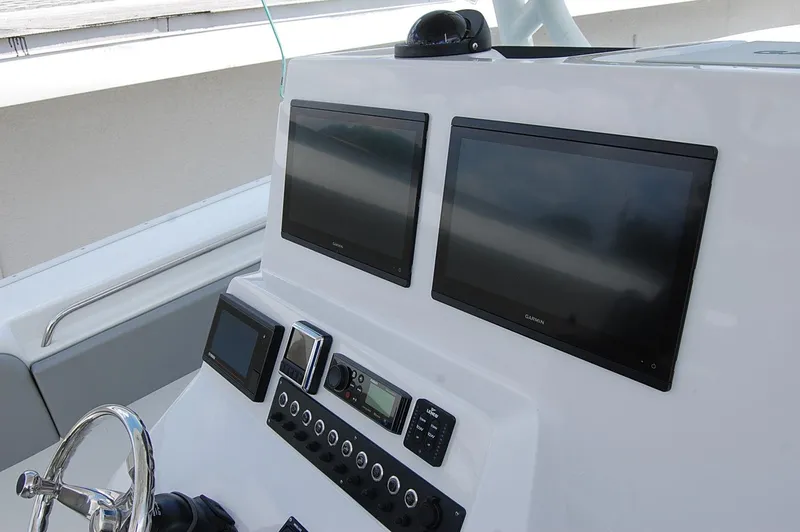 Slide: The Image of Control panel of a 2025 Cape Horn 36 XS boat with dual screens and navigation equipment. - 6
