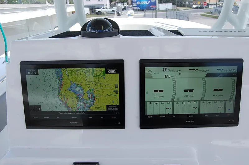 Slide: The Image of Dual navigation screens on the 2025 Cape Horn 36 XS boat dashboard. - 7