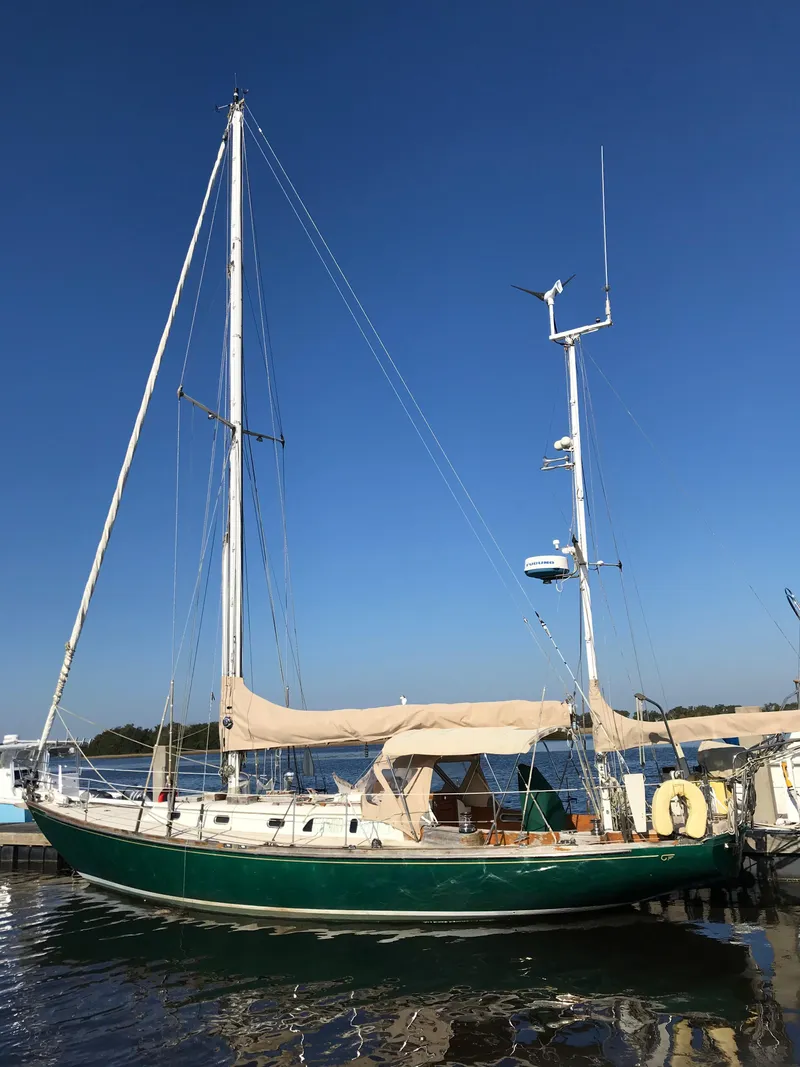 Slide: The Image of 1968 Hinckley Bermuda 40 sailboat docked on a sunny day. - 2