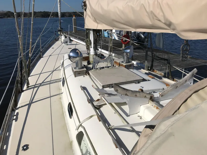 Slide: The Image of 1968 Hinckley Bermuda 40 sailboat deck view, docked on calm water. - 5