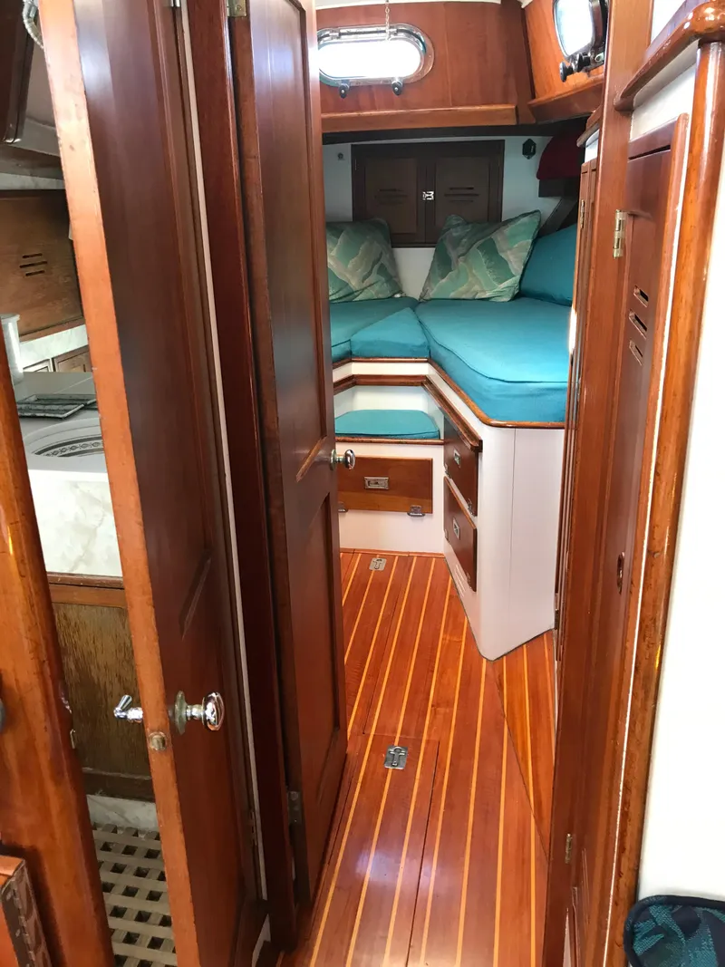 Slide: The Image of 1968 Hinckley Bermuda 40 interior with wood finish and cozy sleeping area. - 8