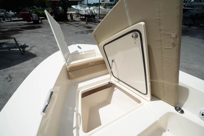 Slide: The Image of 2025 Scout 195 Sportfish boat with open storage compartments. - 10