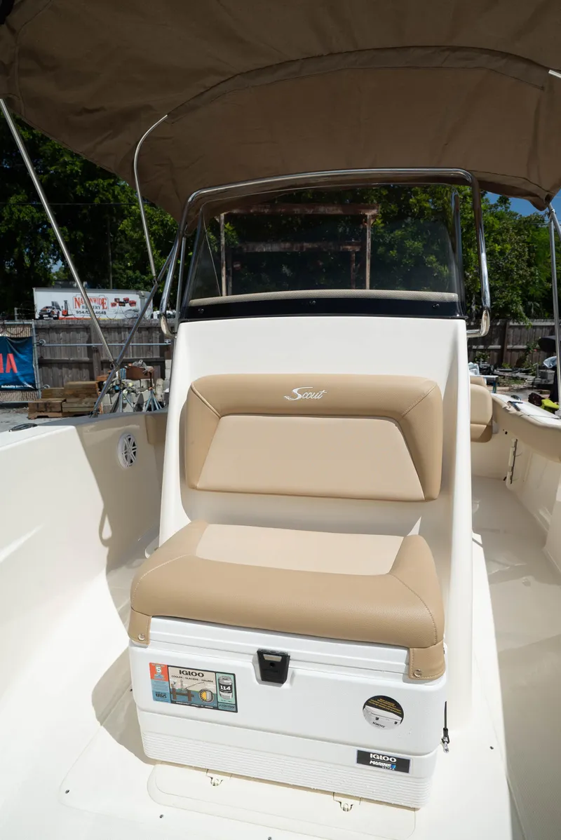 Slide: The Image of 2025 Scout 195 Sportfish boat with tan seating and Igloo cooler. - 13