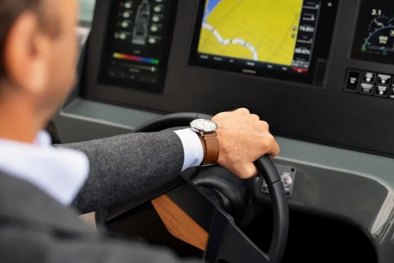 Slide: The Image of Man steering 2023 Aviara AV32 Outboard boat with navigation screens. - 14