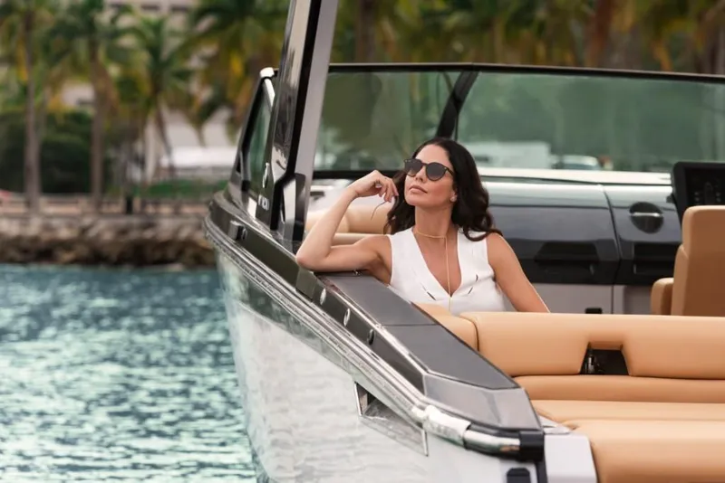 Slide: The Image of Woman relaxing on a 2023 Aviara AV32 Outboard boat in tropical waters. - 3