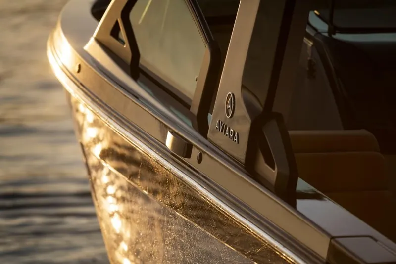 Slide: The Image of 2023 Aviara AV32 Outboard boat side view at sunset. - 6