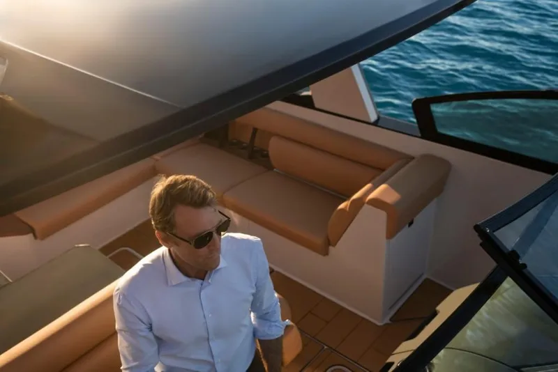 Slide: The Image of Man on 2023 Aviara AV32 Outboard boat, enjoying a sunny day on the water. - 8