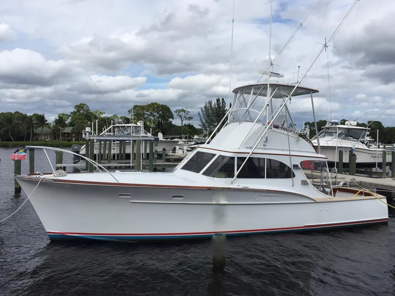 The Image of 1965 Rybovich 37 Sportfish boat docked at marina under cloudy sky. - 0