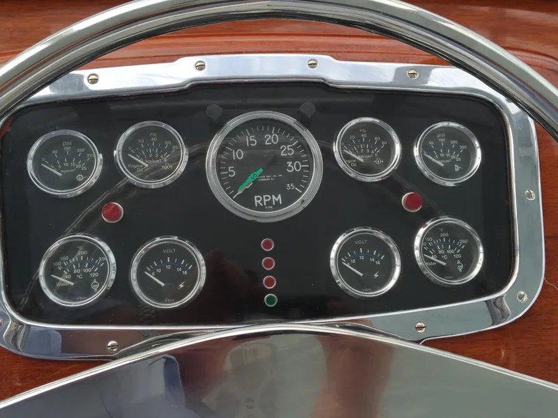 Slide: The Image of Dashboard of a 1965 Rybovich 37 Sportfish boat with multiple gauges and RPM indicator. - 12