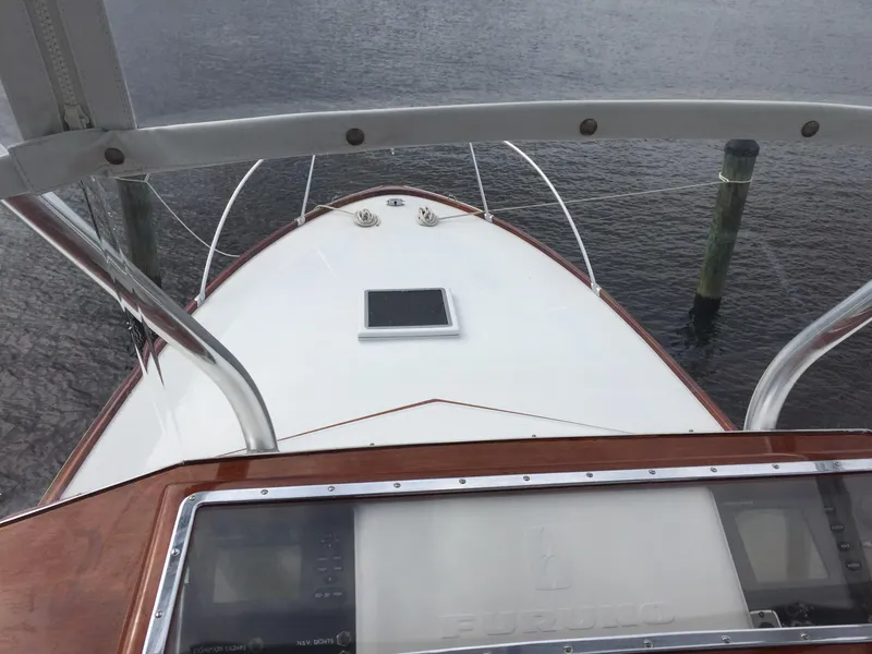 Slide: The Image of 1965 Rybovich 37 Sportfish boat deck view with water and dock posts. - 13