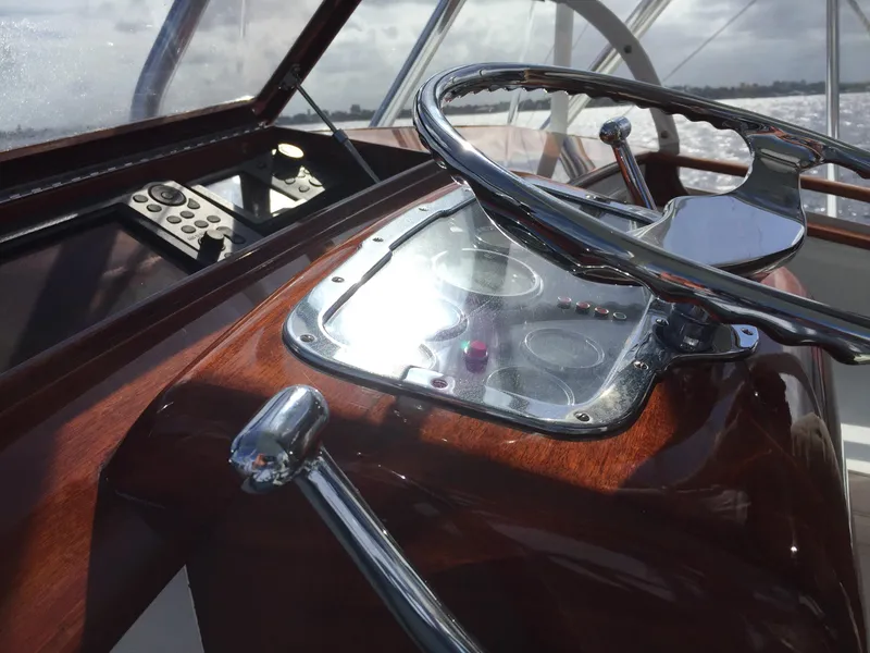 Slide: The Image of 1965 Rybovich 37 Sportfish helm with polished wood and chrome steering wheel. - 19