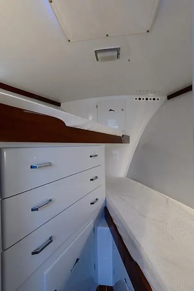 Slide: The Image of 1965 Rybovich 37 Sportfish cabin interior with white cabinetry and wooden accents. - 26