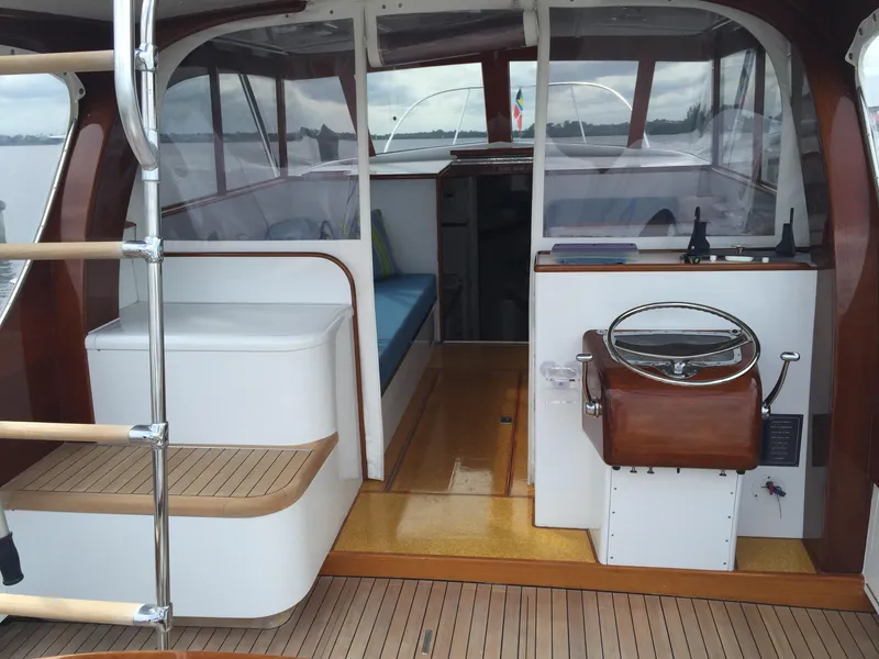 Slide: The Image of 1965 Rybovich 37 Sportfish interior with wooden accents and steering wheel. - 3