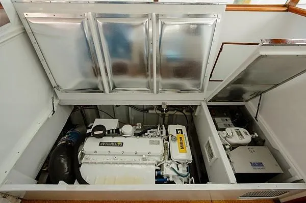 Slide: The Image of Engine compartment of a 1965 Rybovich 37 Sportfish boat, showcasing mechanical components. - 32