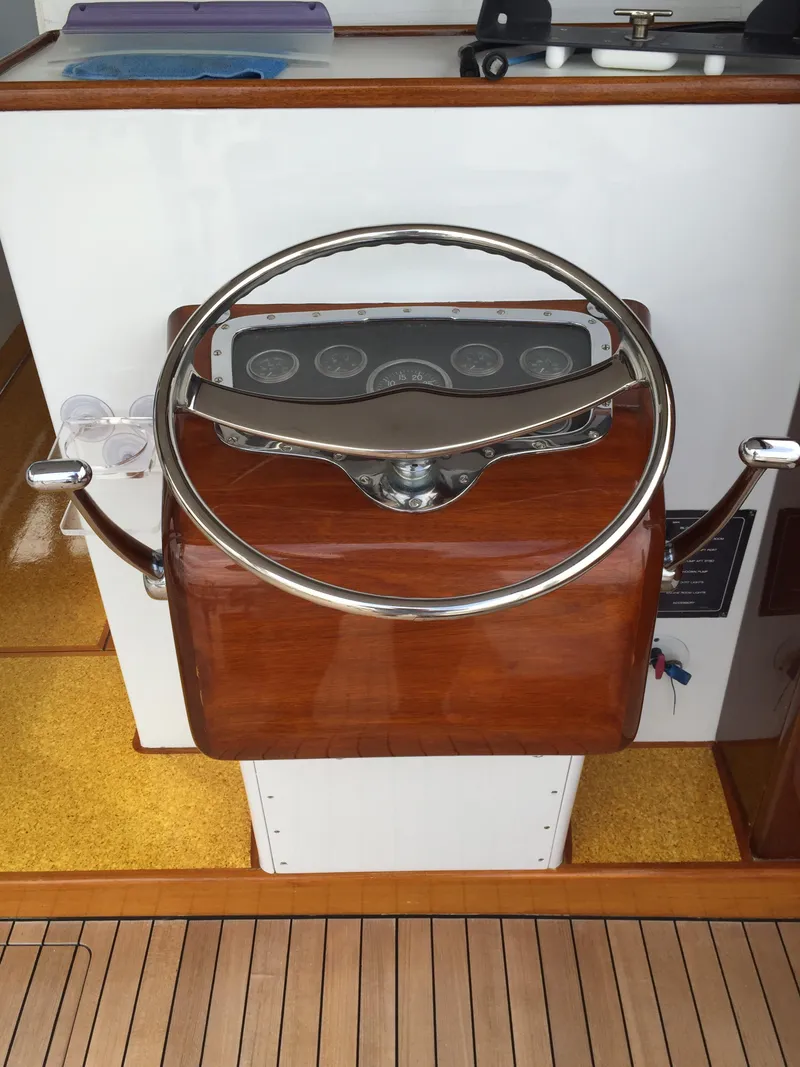 Slide: The Image of Steering wheel of a 1965 Rybovich 37 Sportfish boat, featuring classic wooden design. - 5