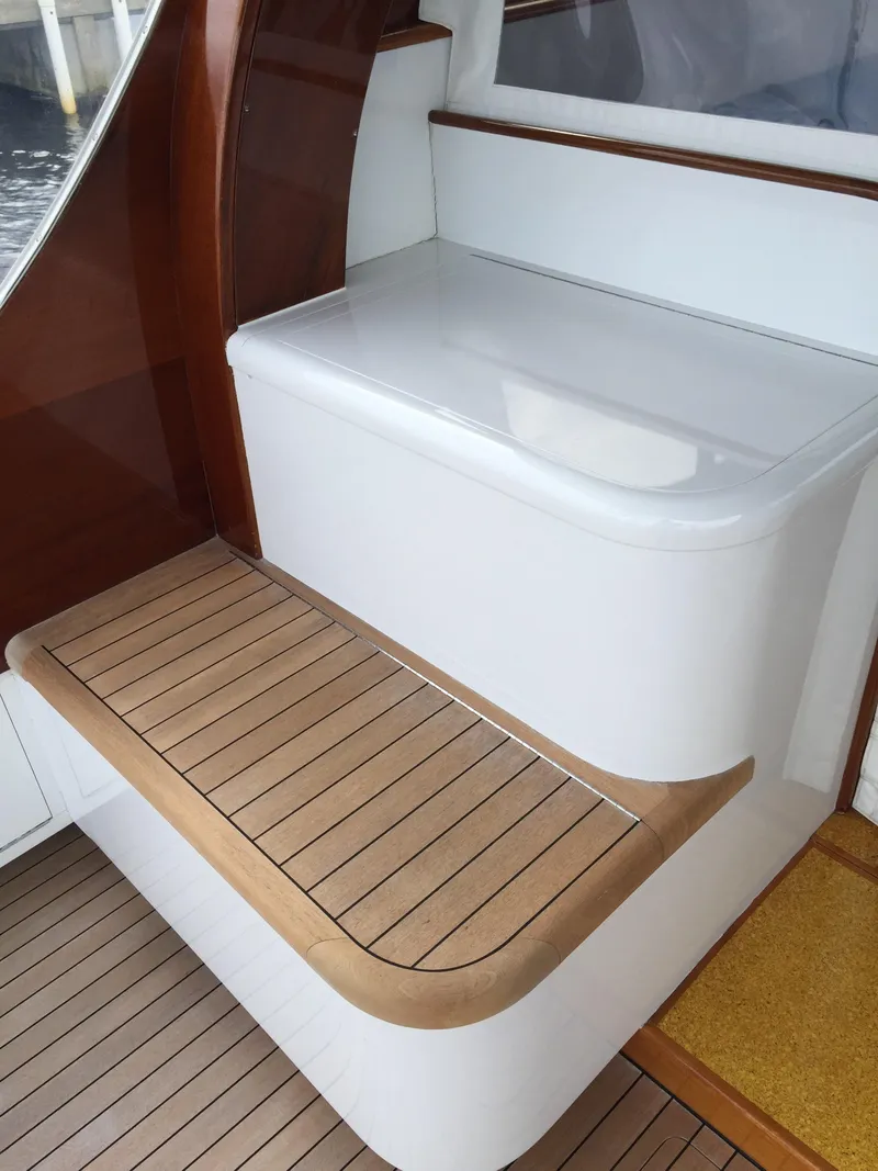 Slide: The Image of 1965 Rybovich 37 Sportfish boat interior with wooden steps and white seating area. - 6