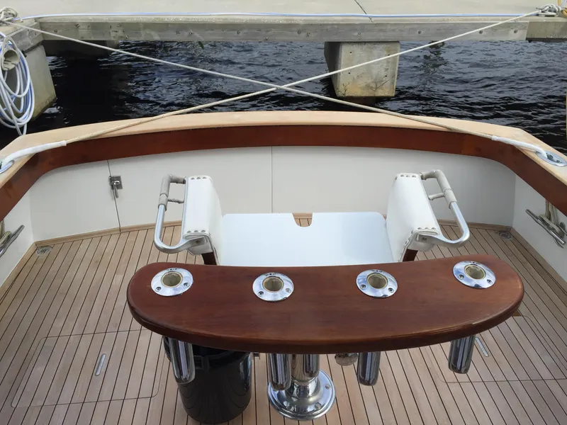 Slide: The Image of 1965 Rybovich 37 Sportfish boat deck with wooden finish and fishing rod holders. - 7