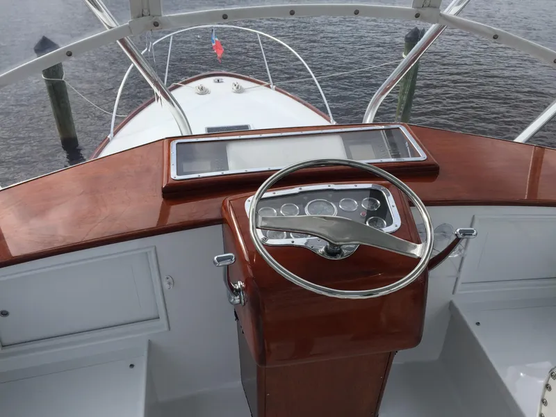 Slide: The Image of 1965 Rybovich 37 Sportfish helm with wooden dashboard and steering wheel, overlooking the bow. - 8