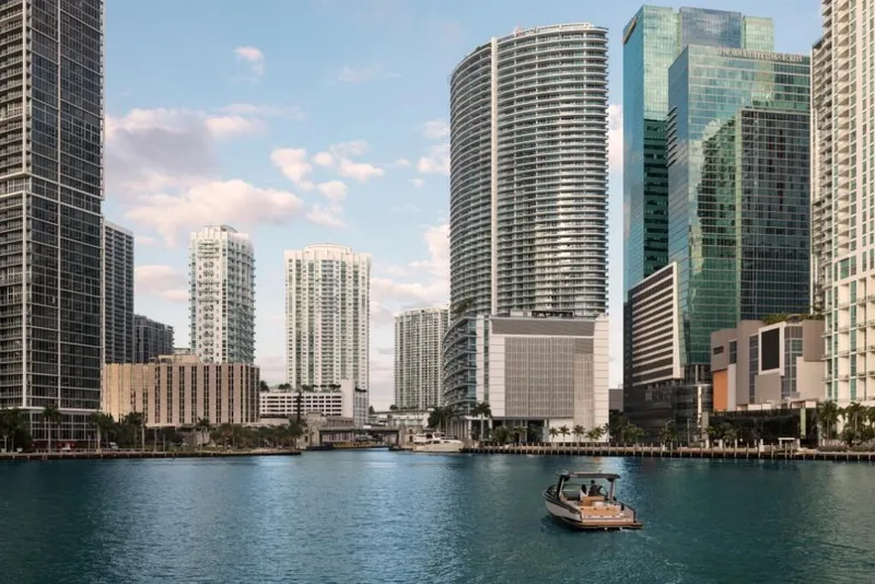 Slide: The Image of Aviara AV32 boat cruising in a city waterfront with modern skyscrapers, 2023. - 17