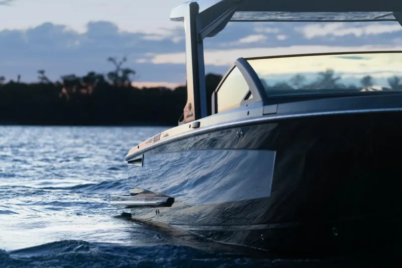 Slide: The Image of 2023 Aviara AV32 boat cruising on water at sunset. - 23