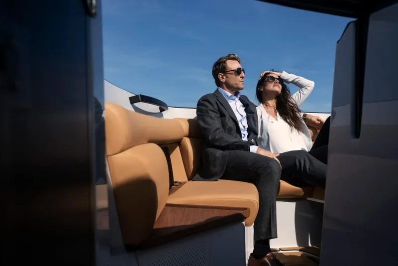 Slide: The Image of Couple relaxing on a 2023 Aviara AV32 boat under clear blue skies. - 8