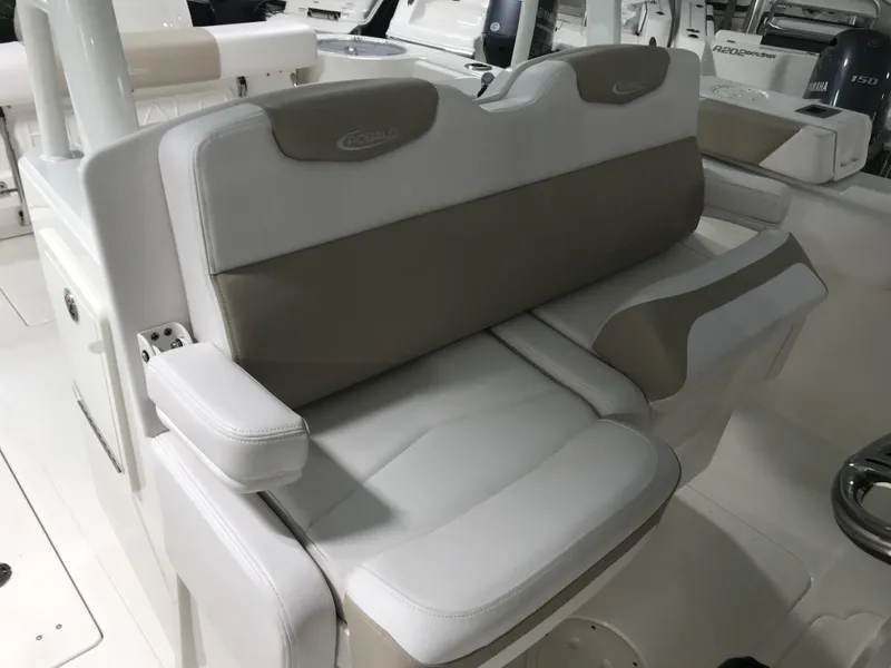 Slide: The Image of 2024 Robalo R302 boat seating area with cushioned seats and armrests. - 10