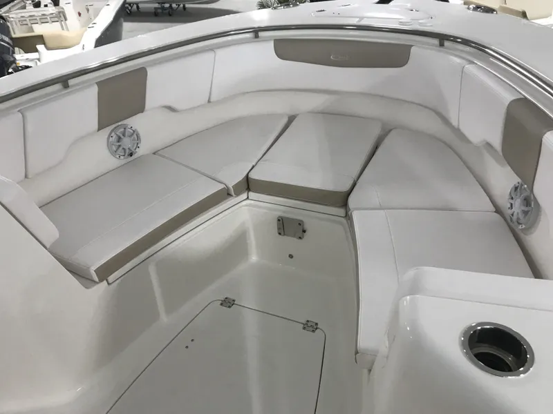 Slide: The Image of 2024 Robalo R302 boat interior with cushioned seating and storage compartments. - 11