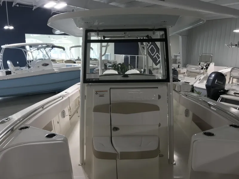 Slide: The Image of 2024 Robalo R302 boat interior at a showroom. - 12
