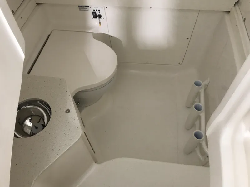 Slide: The Image of 2024 Robalo R302 boat interior with toilet and sink. - 13