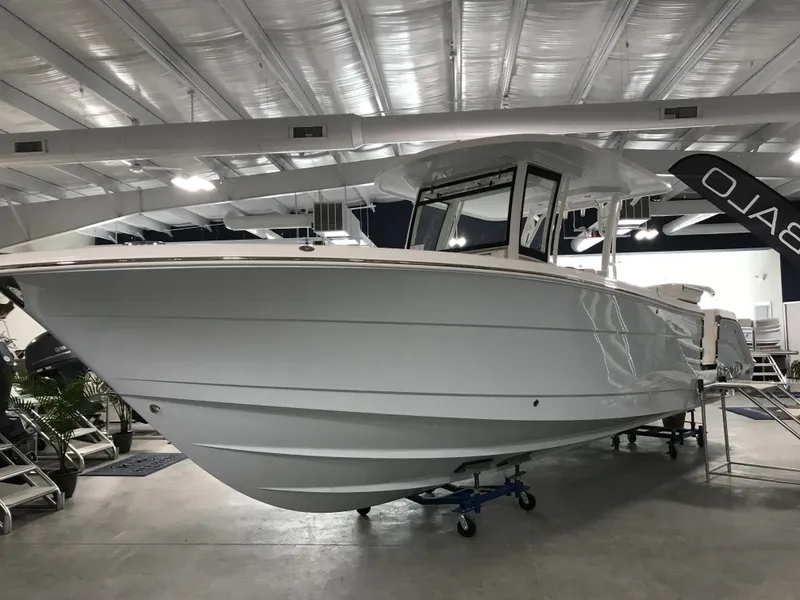 Slide: The Image of 2024 Robalo R302 boat displayed in a showroom. - 3