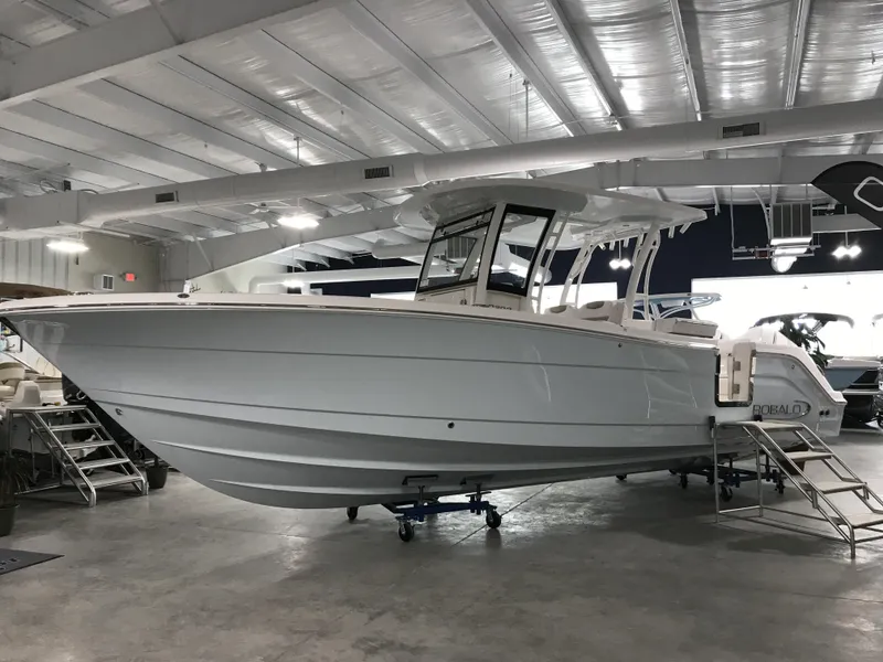 Slide: The Image of 2024 Robalo R302 boat displayed in a showroom. - 4