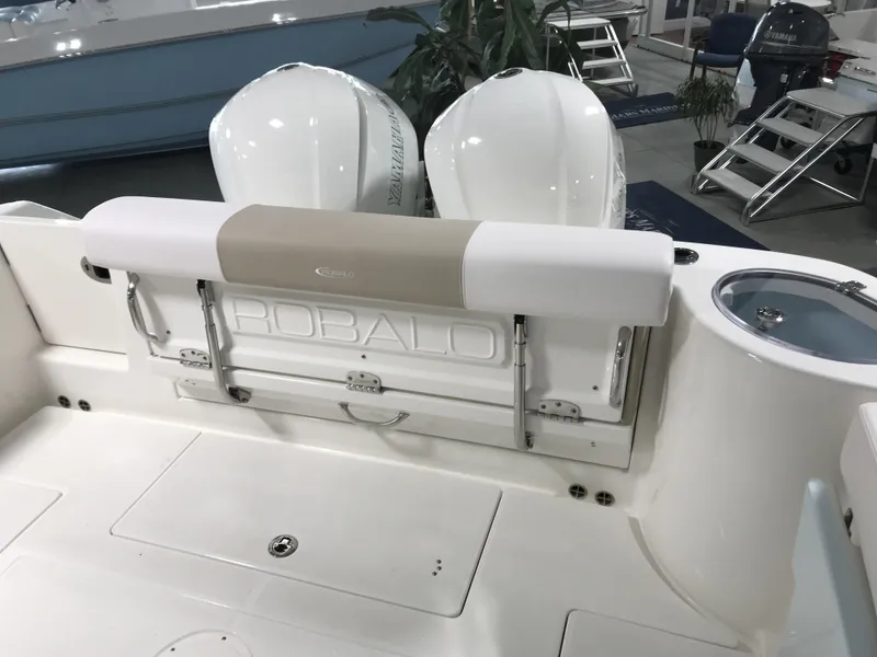 Slide: The Image of 2024 Robalo R302 boat interior with dual outboard engines. - 5