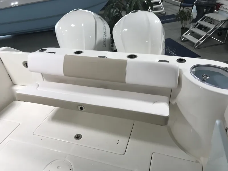 Slide: The Image of 2024 Robalo R302 boat interior with seating and dual outboard engines. - 6