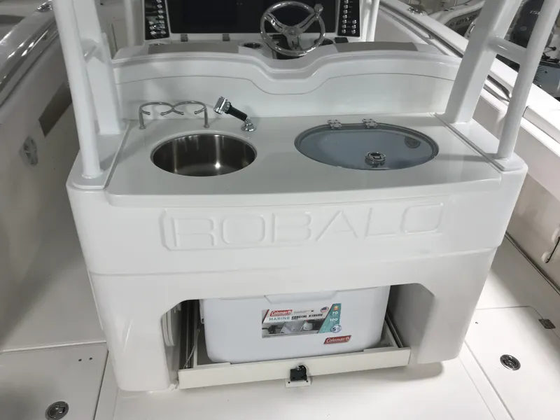 Slide: The Image of 2024 Robalo R302 boat console with sink and storage. - 7