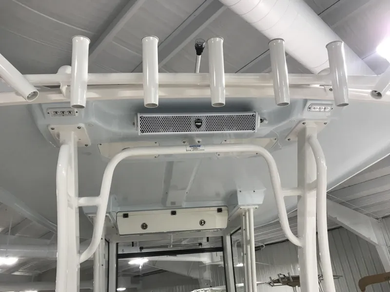 Slide: The Image of 2024 Robalo R302 boat with rod holders and overhead console. - 8