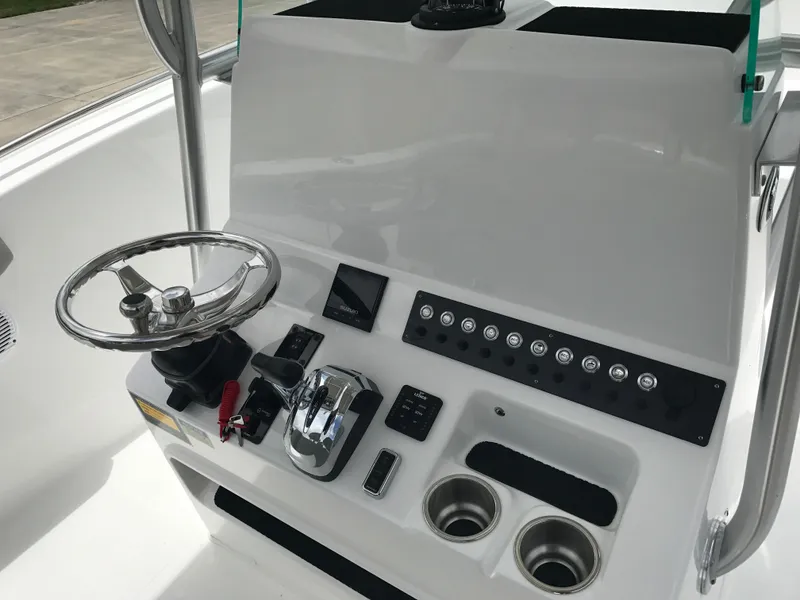 Slide: The Image of 2024 Cape Horn 22OS boat console with steering wheel and control panel. - 7