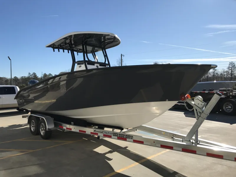 Slide: The Image of 2024 Cape Horn 27 XS boat on a trailer in a parking lot. - 2