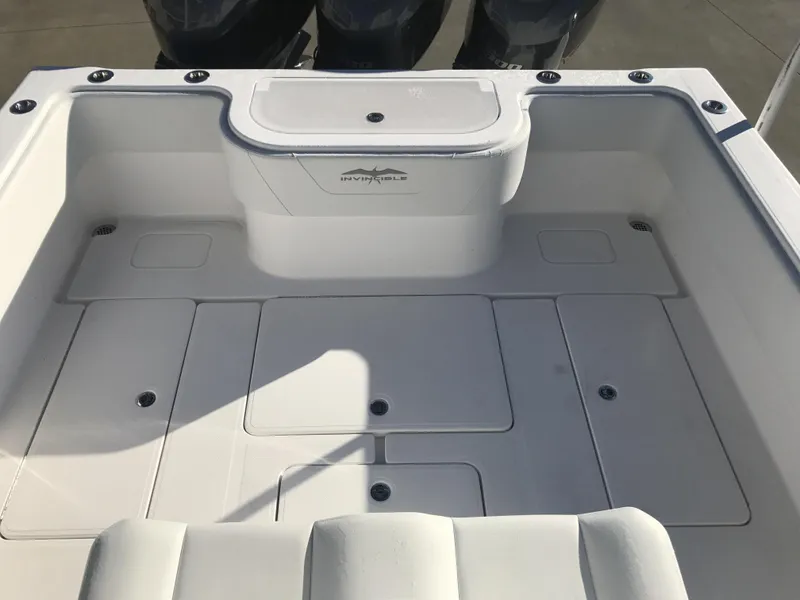 Slide: The Image of 2024 Invincible 36 boat deck with storage compartments and dual outboard motors. - 10