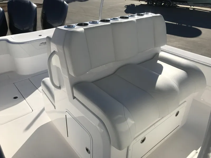 Slide: The Image of 2024 Invincible 36 boat with white cushioned seating and storage compartments. - 19