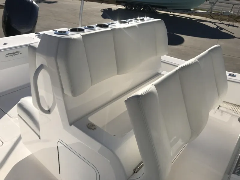 Slide: The Image of 2024 Invincible 36 boat seating with cup holders and white upholstery. - 20