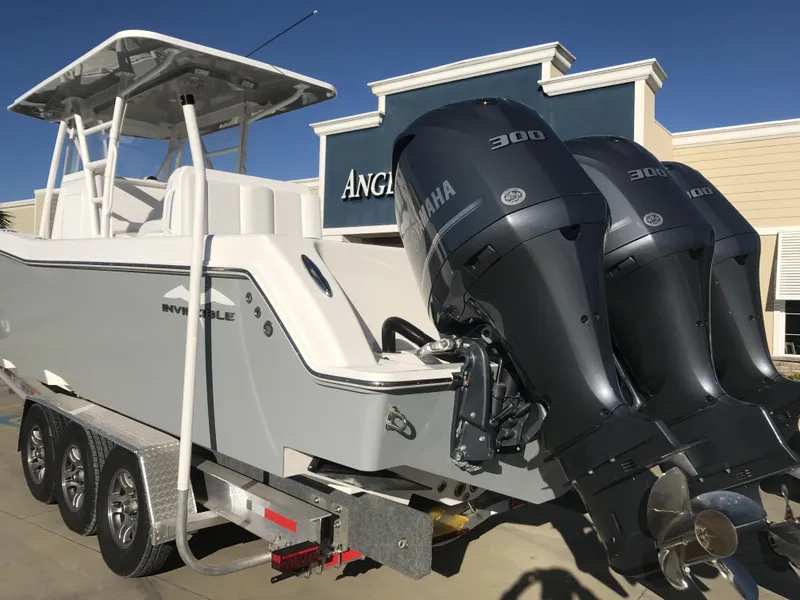 Slide: The Image of 2024 Invincible 36 boat with twin Yamaha 300 engines on a trailer. - 5
