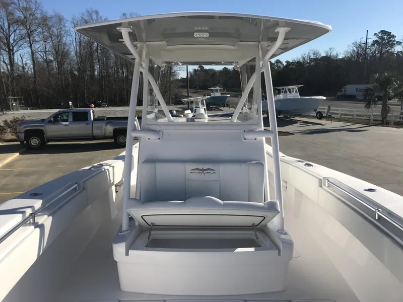 Slide: The Image of 2024 Invincible 36 boat with center console and seating, parked outdoors. - 9