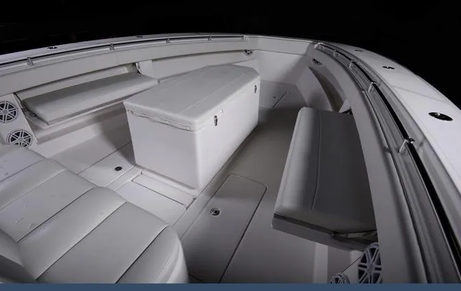Slide: The Image of 2024 Invincible 42 boat interior with white seating and storage. - 9