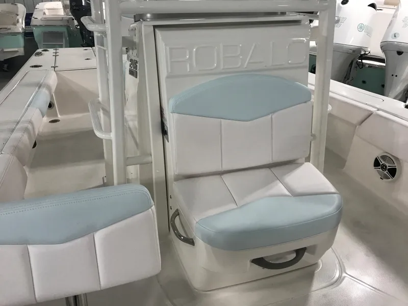 Slide: The Image of 2024 Robalo 246 Cayman Sky Deck boat interior with cushioned seating. - 10