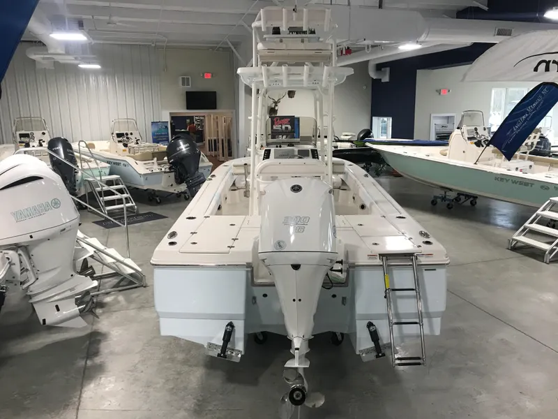 Slide: The Image of 2024 Robalo 246 Cayman Sky Deck boat displayed in a showroom. - 3