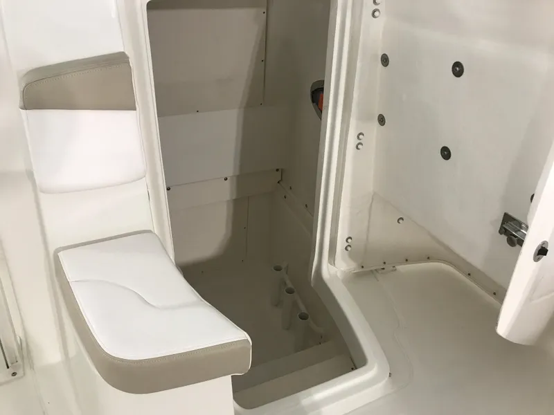 Slide: The Image of Interior view of 2024 Robalo R302 boat showing seating and storage area. - 16