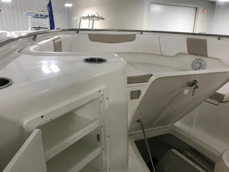 Slide: The Image of 2024 Robalo R302 boat interior with open storage compartments and seating area. - 19