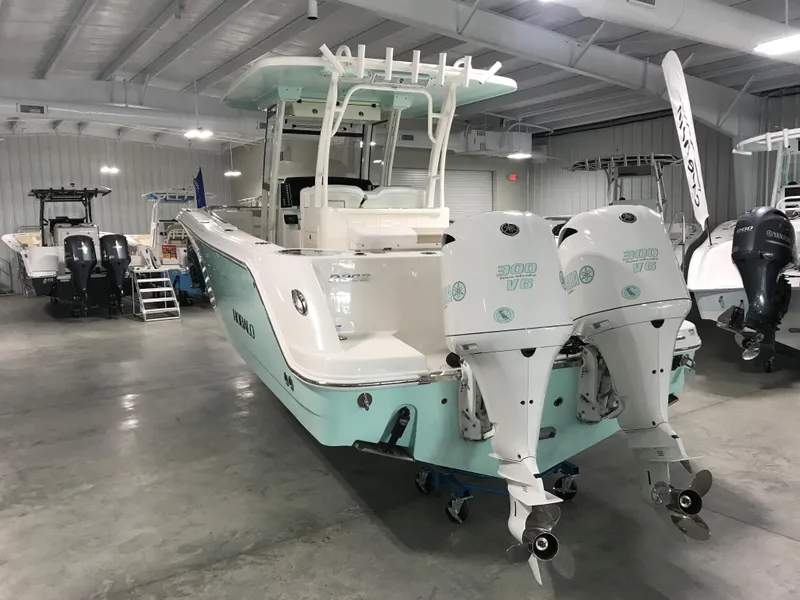 Slide: The Image of 2024 Robalo R302 boat with twin engines in a showroom. - 2