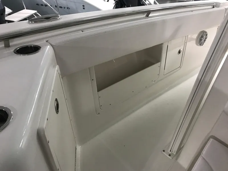 Slide: The Image of 2024 Robalo R302 boat interior storage compartment and rod holders. - 22